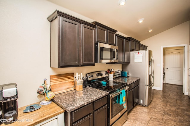 7023 35th St, Lubbock, TX 79407 - kitchen featuring vaulted ceiling, dark stone countertops, dark brown cabinets, and appliances with stainless steel finishes