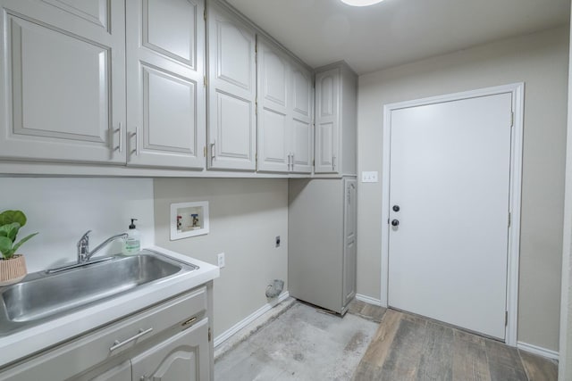 laundry area featuring sink, cabinets, light wood-type flooring, electric dryer hookup, and washer hookup