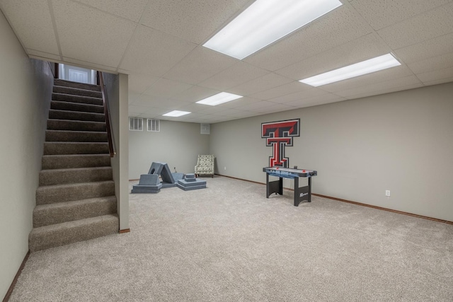 game room featuring carpet and a drop ceiling