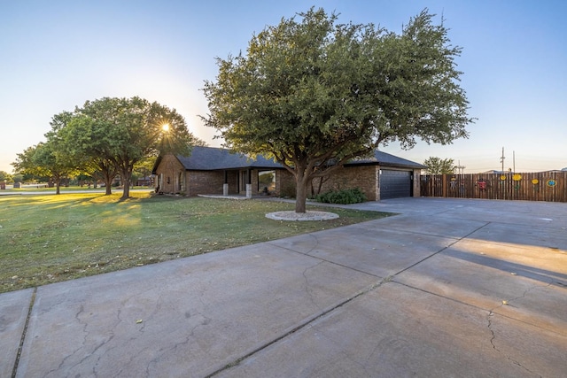 view of front of home featuring a garage and a lawn