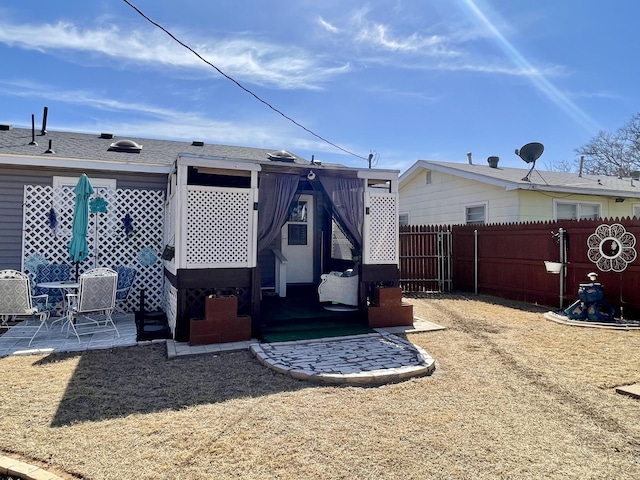 back of property with a patio area and fence
