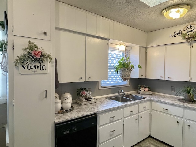 kitchen with white cabinets, dishwasher, light countertops, and a sink