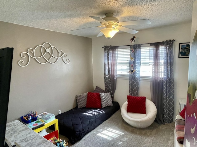 interior space with carpet floors, a textured ceiling, and a ceiling fan