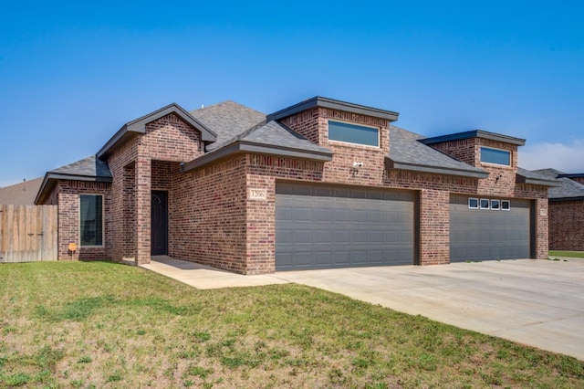 view of front of house featuring a garage and a front yard