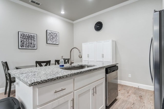 kitchen featuring sink, light stone counters, light hardwood / wood-style flooring, stainless steel appliances, and white cabinets