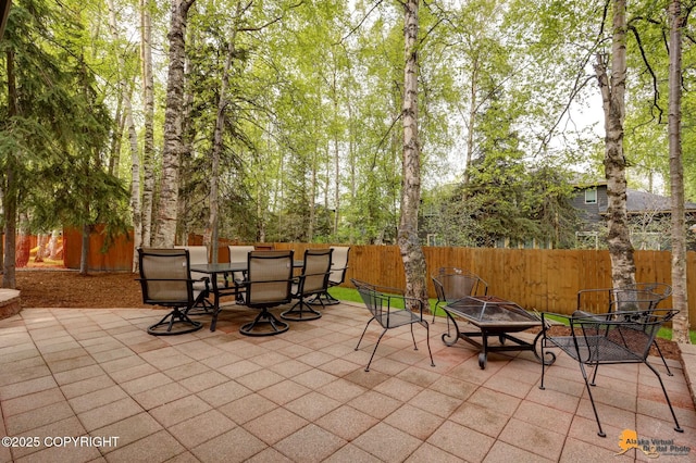 13610 Arboretum St, Anchorage, AK 99516 - fenced backyard featuring an outdoor fire pit, a patio, and outdoor dining space