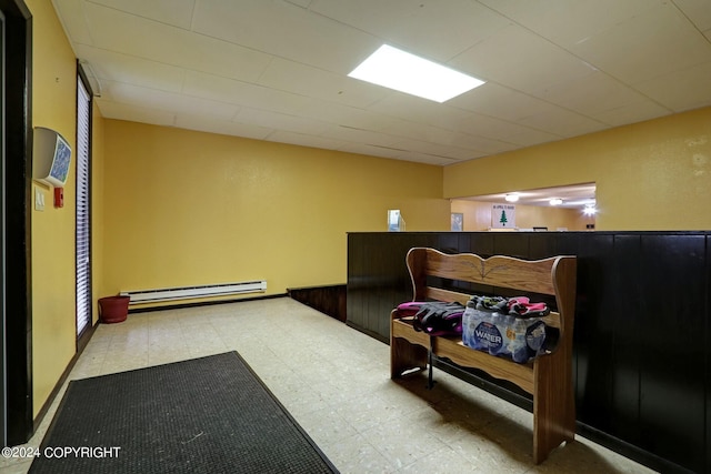 bedroom featuring baseboard heating and light tile flooring