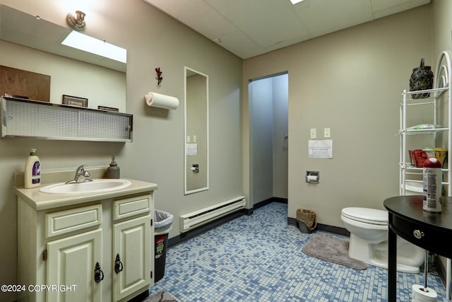 bathroom with tile floors, a baseboard radiator, large vanity, and toilet