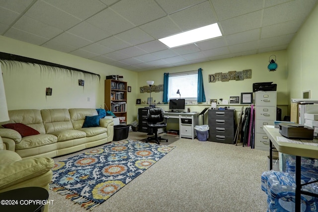 carpeted office with a paneled ceiling