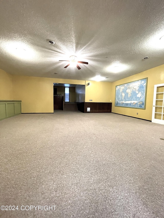 spare room featuring carpet and a textured ceiling