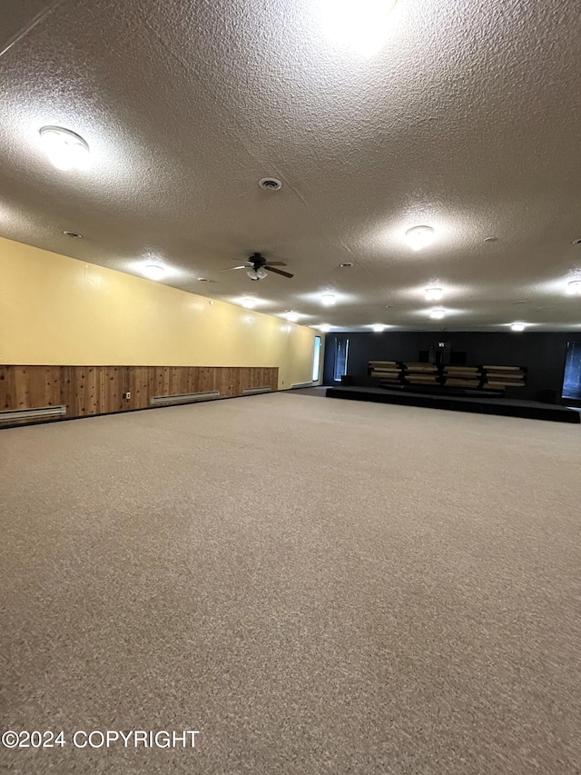 garage featuring a baseboard heating unit and ceiling fan