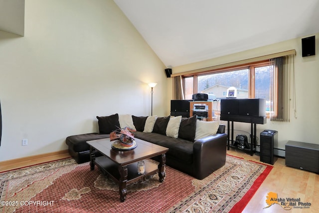 living area with a baseboard heating unit, baseboards, high vaulted ceiling, and wood finished floors