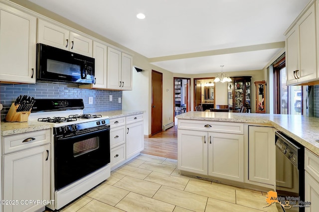 kitchen with a peninsula, an inviting chandelier, decorative backsplash, black appliances, and white cabinets