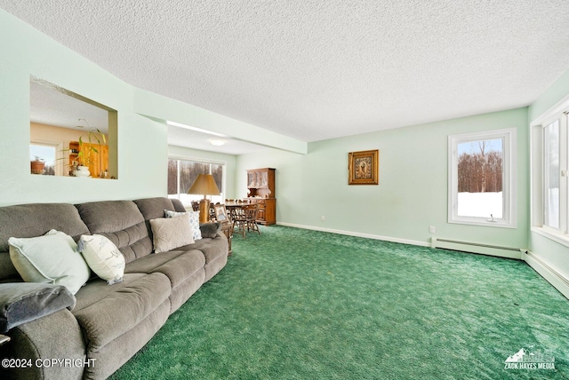 carpeted living room with a baseboard heating unit and a textured ceiling