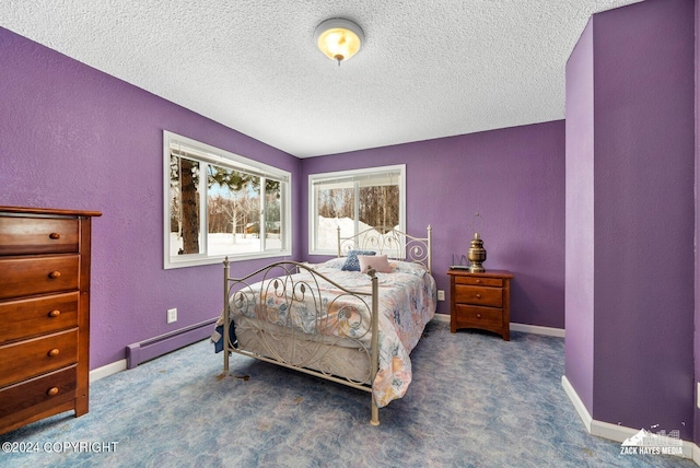 bedroom with baseboard heating, dark carpet, and a textured ceiling