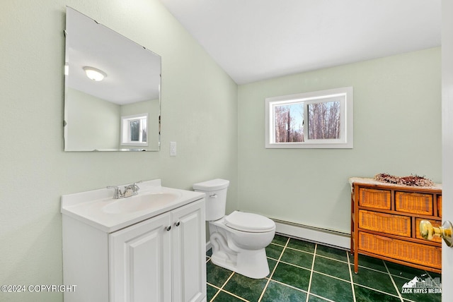 bathroom featuring toilet, tile floors, vanity, and baseboard heating