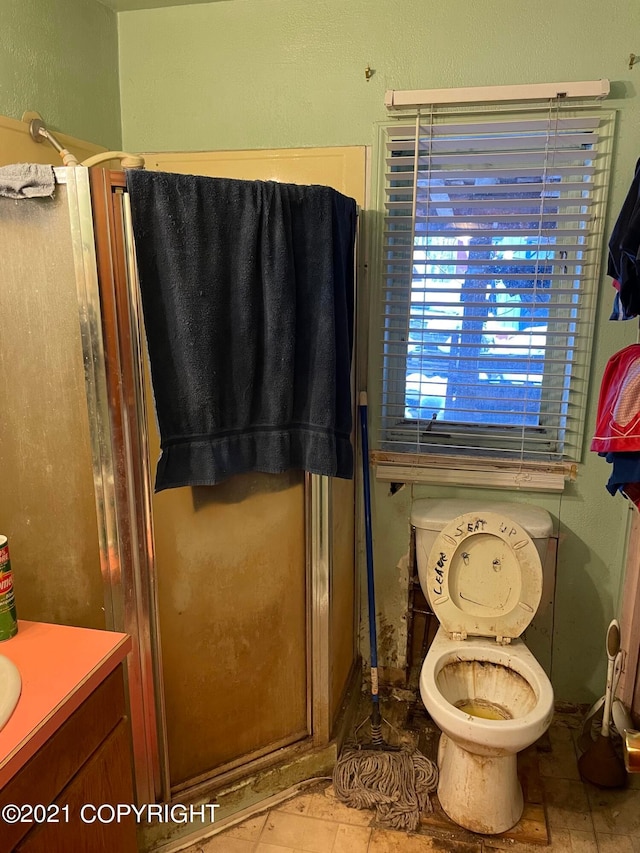 bathroom with vanity, tile floors, and toilet