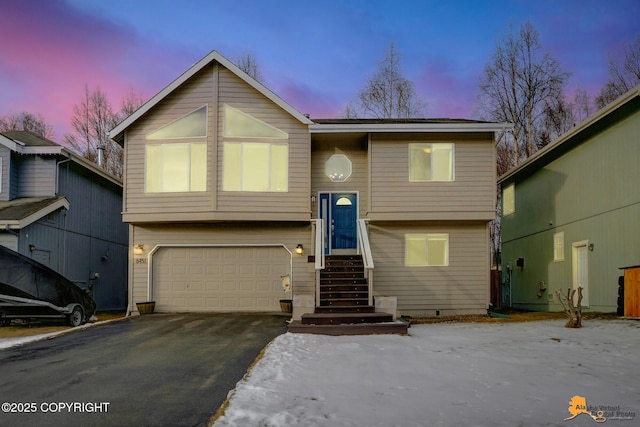 bi-level home with crawl space, driveway, and an attached garage