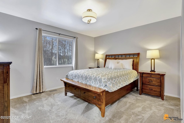 bedroom with light carpet and baseboards