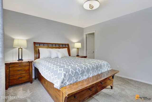 bedroom with baseboards and light colored carpet