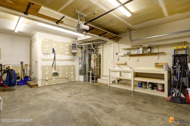 garage featuring a sink, secured water heater, a workshop area, and a garage door opener