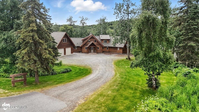 33405 Keystone Dr, Soldotna, AK 99669 - log cabin with driveway, a front lawn, and a forest view