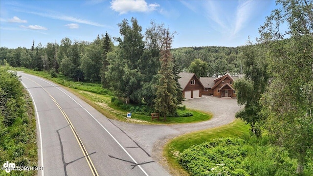 33405 Keystone Dr, Soldotna, AK 99669 - view of asphalt driveway with a forest view