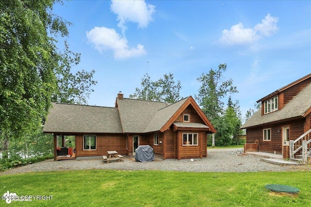 33405 Keystone Dr, Soldotna, AK 99669 - back of house with a lawn, a chimney, and a shingled roof