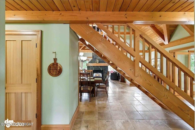 33405 Keystone Dr, Soldotna, AK 99669 - corridor featuring a wooden ceiling with exposed beams, stairway, and stone tile floors
