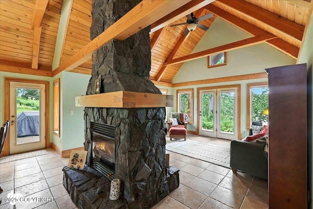 33405 Keystone Dr, Soldotna, AK 99669 - living area featuring a wooden ceiling with exposed beams, french doors, a stone fireplace, a ceiling fan, and high vaulted ceiling