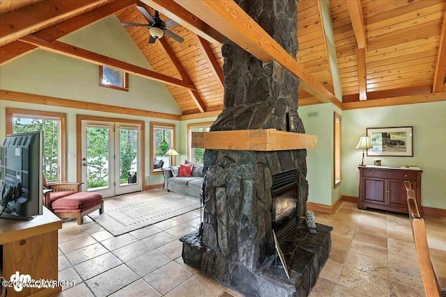 33405 Keystone Dr, Soldotna, AK 99669 - living area with a wooden ceiling with exposed beams, ceiling fan, a stone fireplace, stone tile floors, and high vaulted ceiling