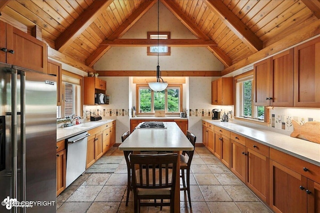 33405 Keystone Dr, Soldotna, AK 99669 - kitchen featuring stainless steel appliances, light countertops, a wood ceiling with exposed beams, stone tile flooring, and a kitchen island