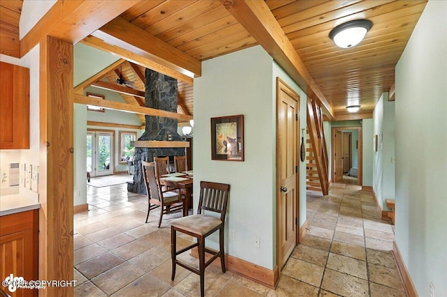 33405 Keystone Dr, Soldotna, AK 99669 - hallway featuring stone tile floors, a wooden ceiling with exposed beams, and stairway
