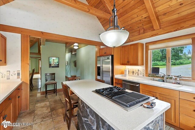 33405 Keystone Dr, Soldotna, AK 99669 - kitchen featuring appliances with stainless steel finishes, high vaulted ceiling, brown cabinetry, light countertops, and pendant lighting