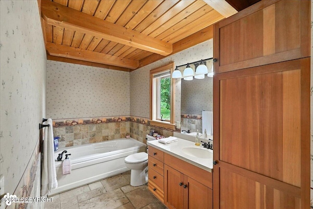 33405 Keystone Dr, Soldotna, AK 99669 - bathroom featuring a garden tub, wallpapered walls, vanity, stone tile flooring, and a wood ceiling with exposed beams