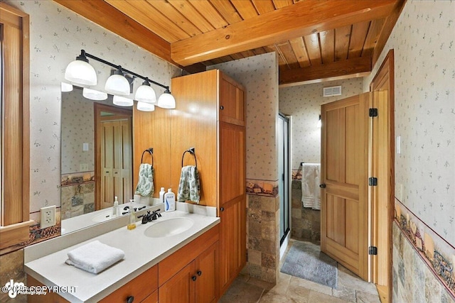 33405 Keystone Dr, Soldotna, AK 99669 - bathroom featuring wallpapered walls, a wooden ceiling with exposed beams, vanity, a shower stall, and stone finish floors