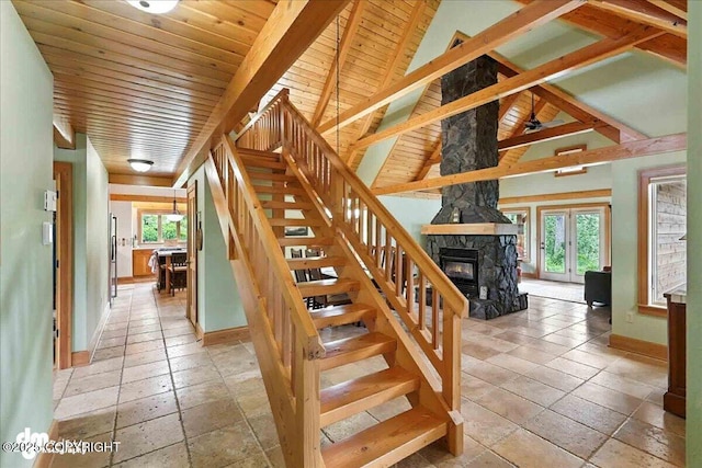 33405 Keystone Dr, Soldotna, AK 99669 - stairway featuring a stone fireplace, stone tile flooring, and wood ceiling