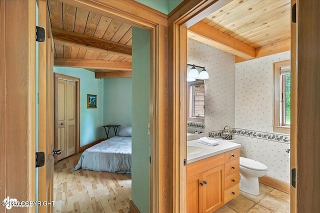 33405 Keystone Dr, Soldotna, AK 99669 - bathroom featuring a wooden ceiling with exposed beams, wallpapered walls, vanity, and wood finished floors