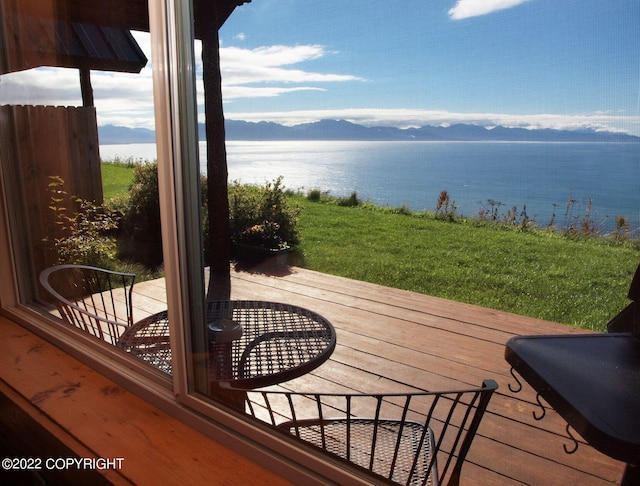 wooden deck featuring a lawn and a water and mountain view