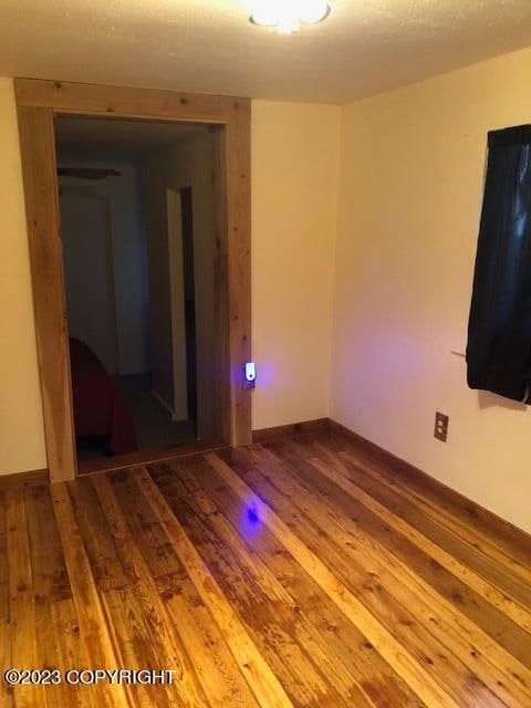 unfurnished room featuring hardwood / wood-style flooring