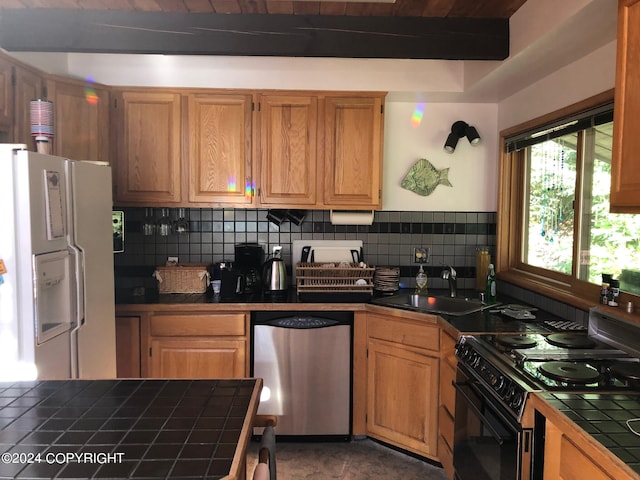 kitchen with black range, backsplash, dishwasher, tile countertops, and white refrigerator with ice dispenser