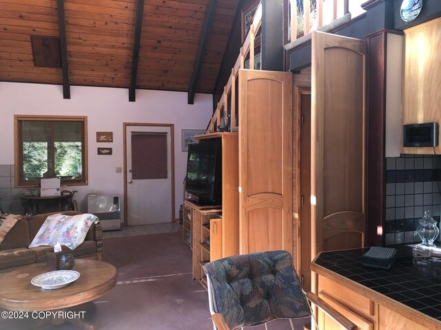 interior space with tile counters, high vaulted ceiling, wooden ceiling, and beam ceiling