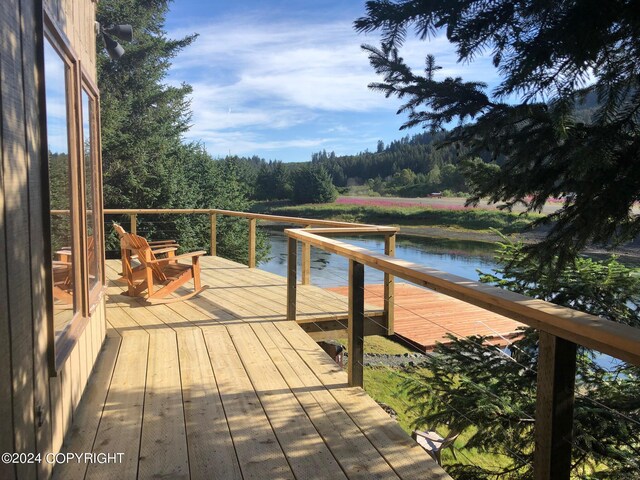 wooden terrace featuring a water view