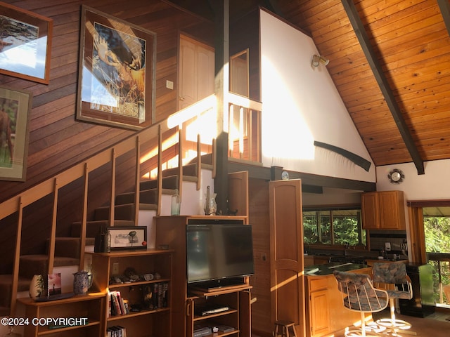 interior space featuring wooden ceiling, wood walls, high vaulted ceiling, and beam ceiling