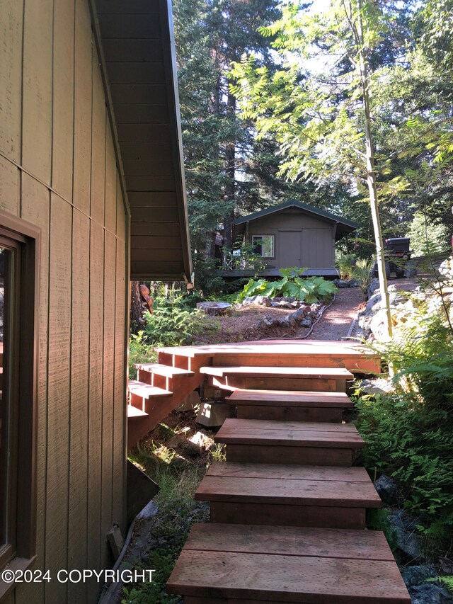 wooden deck with a storage shed