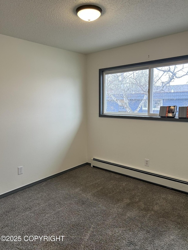 3940 E 9th Ave, Anchorage, AK 99508 - spare room with baseboard heating, baseboards, carpet floors, and a textured ceiling