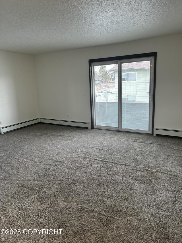 3940 E 9th Ave, Anchorage, AK 99508 - spare room featuring baseboard heating, carpet flooring, a textured ceiling, and a baseboard radiator