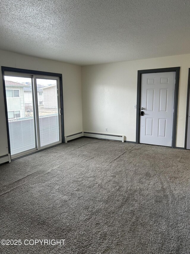 3940 E 9th Ave, Anchorage, AK 99508 - empty room featuring a baseboard radiator, a textured ceiling, and carpet