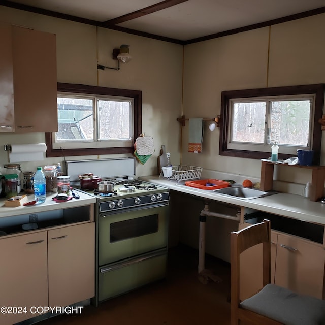 kitchen with white cabinets, a wealth of natural light, and range with gas stovetop