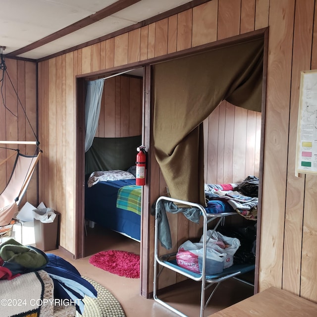 bedroom with wood walls